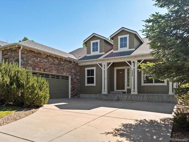 7254 S Kellerman Way, Aurora, CO 80016 - view of front of house featuring driveway, covered porch, stone siding, an attached garage, and roof with shingles