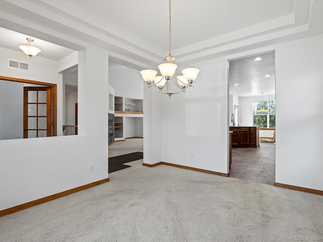 7254 S Kellerman Way, Aurora, CO 80016 - empty room featuring a chandelier, light colored carpet, and a raised ceiling
