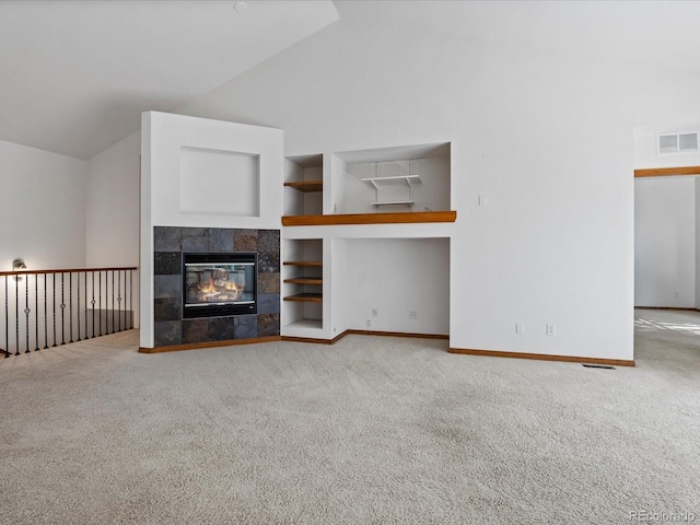 7254 S Kellerman Way, Aurora, CO 80016 - unfurnished living room with lofted ceiling, carpet floors, built in shelves, and a fireplace