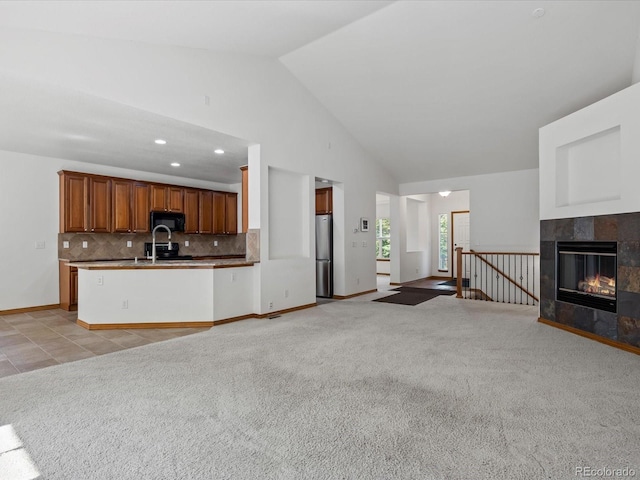 7254 S Kellerman Way, Aurora, CO 80016 - unfurnished living room with vaulted ceiling, light colored carpet, recessed lighting, and a fireplace