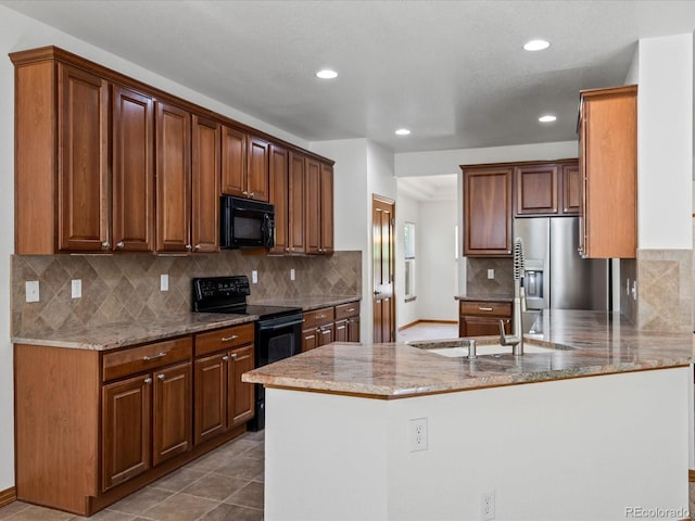 7254 S Kellerman Way, Aurora, CO 80016 - kitchen featuring black appliances, a peninsula, light stone countertops, recessed lighting, and tasteful backsplash