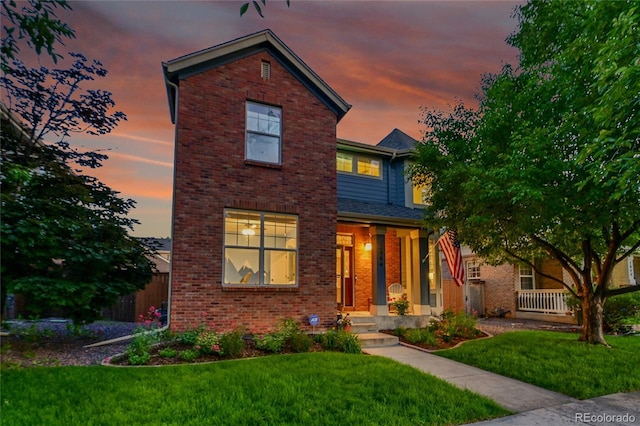 7064 E 2nd Ave, Denver, CO 80220 - traditional home with brick siding and a front yard