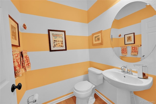 7064 E 2nd Ave, Denver, CO 80220 - half bathroom featuring wood finished floors and toilet