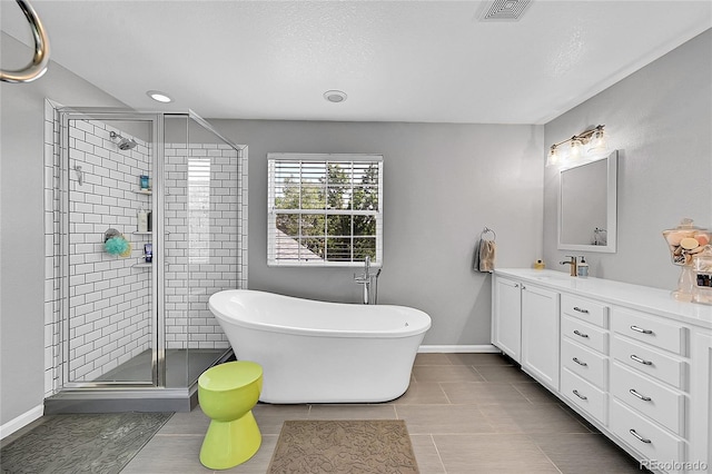7064 E 2nd Ave, Denver, CO 80220 - full bath with vanity, a shower stall, a freestanding bath, tile patterned floors, and baseboards