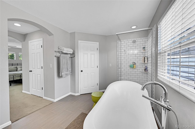 7064 E 2nd Ave, Denver, CO 80220 - ensuite bathroom with a soaking tub, baseboards, a stall shower, recessed lighting, and wood tiled floors