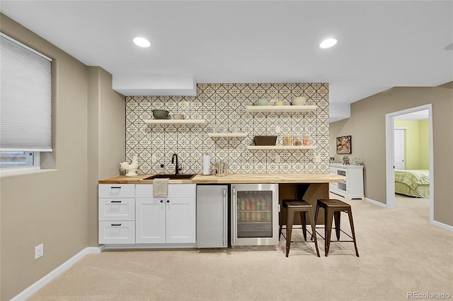 7064 E 2nd Ave, Denver, CO 80220 - indoor wet bar featuring wine cooler, refrigerator, light colored carpet, baseboards, and recessed lighting