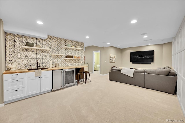 7064 E 2nd Ave, Denver, CO 80220 - living room featuring beverage cooler, wet bar, light carpet, recessed lighting, and baseboards