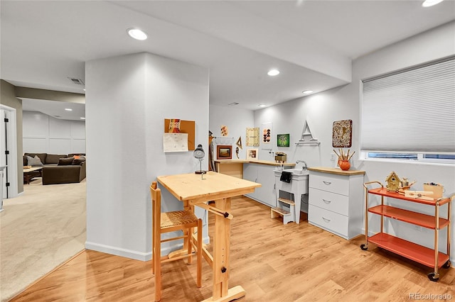 7064 E 2nd Ave, Denver, CO 80220 - kitchen featuring light wood finished floors, recessed lighting, baseboards, white cabinetry, and a sink