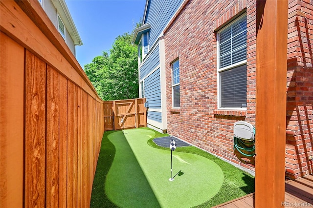7064 E 2nd Ave, Denver, CO 80220 - fenced backyard with a putting area