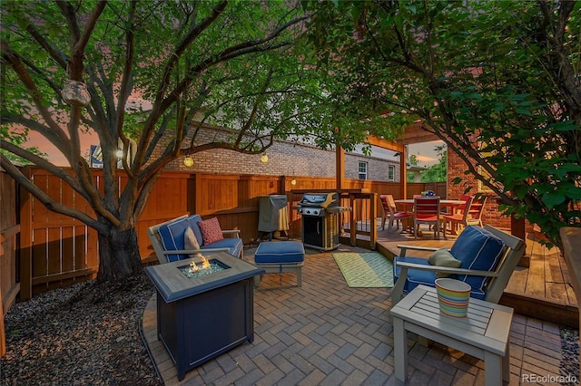 7064 E 2nd Ave, Denver, CO 80220 - fenced backyard with an outdoor fire pit, outdoor dining area, area for grilling, a wooden deck, and a patio