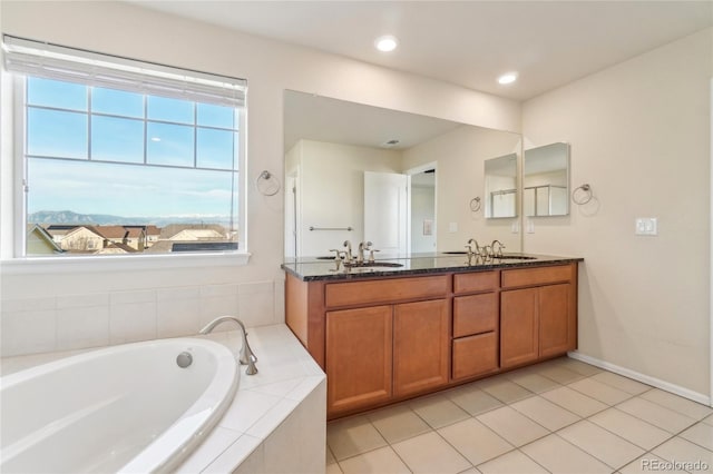 bathroom featuring double vanity, recessed lighting, a bath, tile patterned floors, and a sink