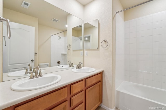 bathroom with visible vents, toilet, and a sink