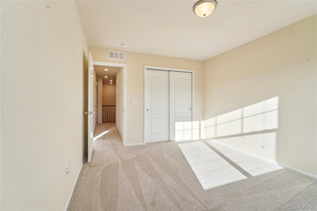 unfurnished bedroom featuring a closet, baseboards, visible vents, and carpet flooring