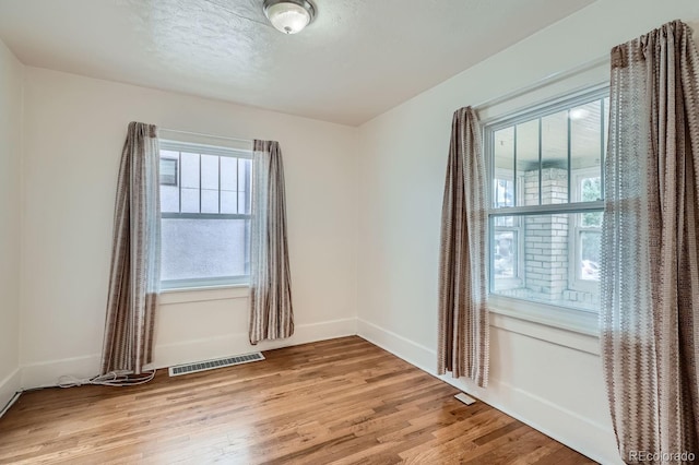 spare room featuring light wood-type flooring