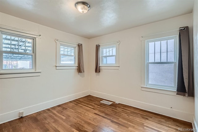 empty room featuring wood-type flooring