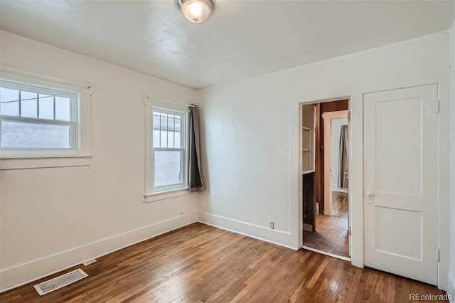 unfurnished bedroom with hardwood / wood-style flooring