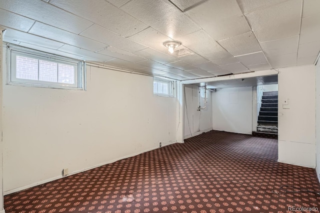 basement with dark colored carpet