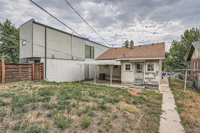 rear view of property with central AC unit and a patio area