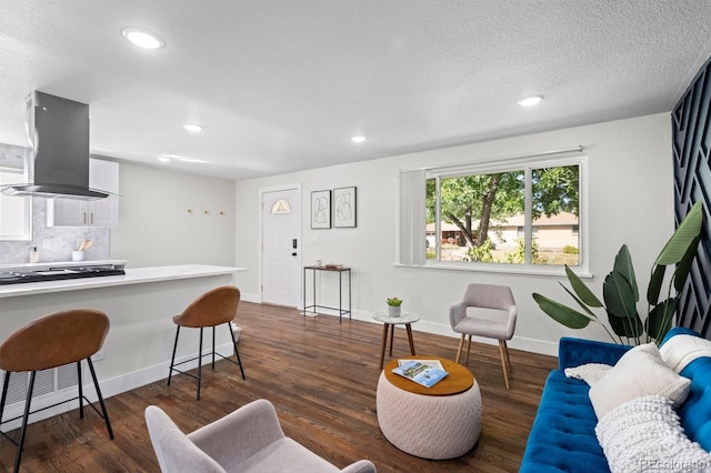 living room with a textured ceiling and dark wood-type flooring