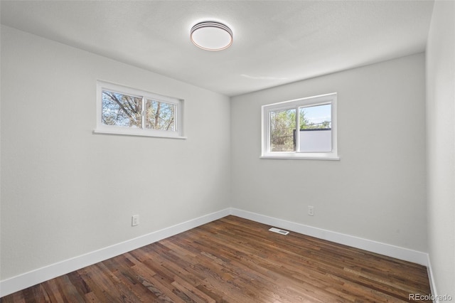 empty room featuring dark hardwood / wood-style flooring