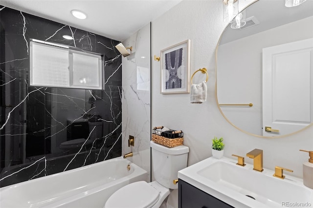 full bathroom featuring vanity, toilet, and tiled shower / bath