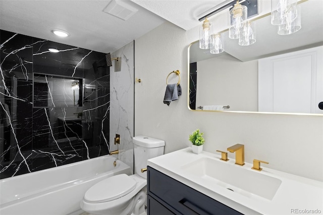 full bathroom with toilet, vanity, and tiled shower / bath