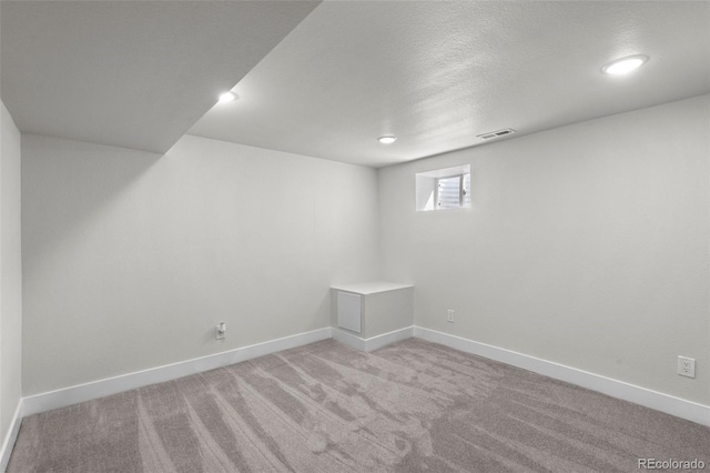 basement with light colored carpet