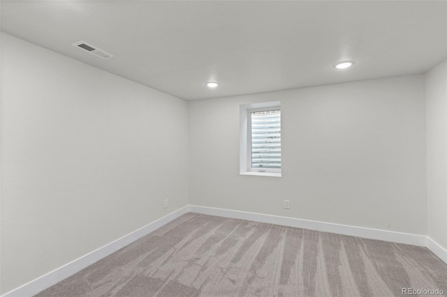 unfurnished room with light carpet