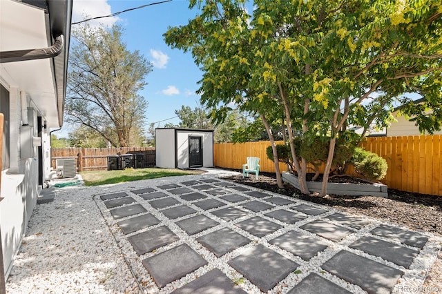 view of patio with cooling unit and a shed