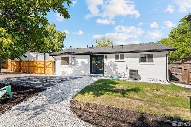 back of house with a patio, a lawn, and central air condition unit