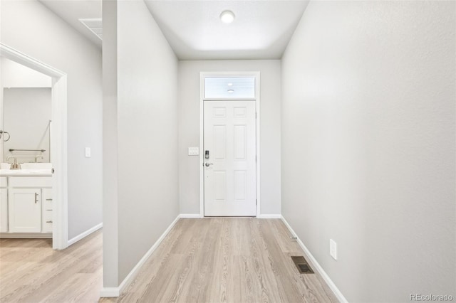 1957 S Coolidge Way, Aurora, CO 80018 - doorway with light wood-style floors and baseboards