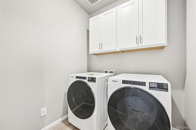1957 S Coolidge Way, Aurora, CO 80018 - laundry area with cabinet space, independent washer and dryer, and baseboards