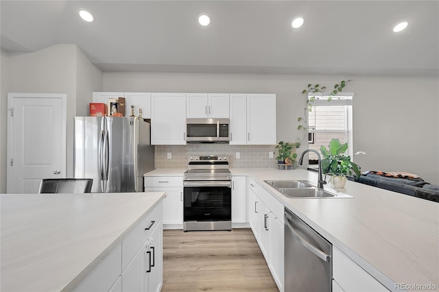 503 Bobcat Ct, Wiggins, CO 80654 - kitchen with appliances with stainless steel finishes, a sink, light countertops, decorative backsplash, and white cabinetry