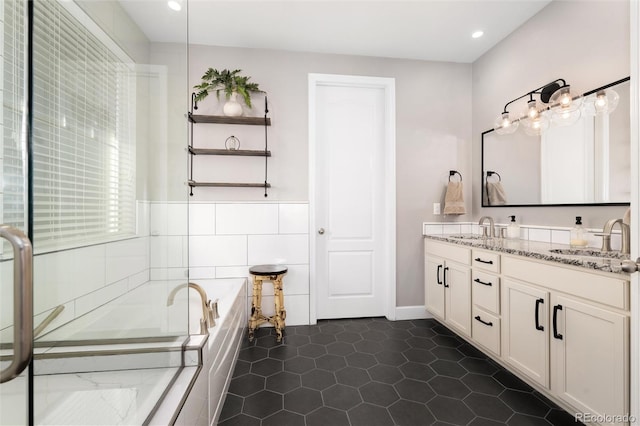 bathroom with vanity, a tub to relax in, and tile patterned floors