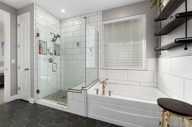 bathroom featuring plus walk in shower and tile patterned floors