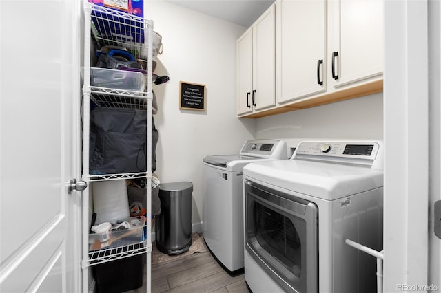 laundry room featuring cabinets and washer and clothes dryer