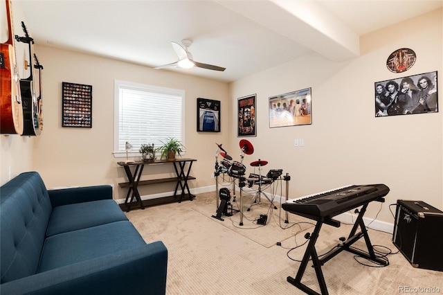 exercise room with light colored carpet and ceiling fan