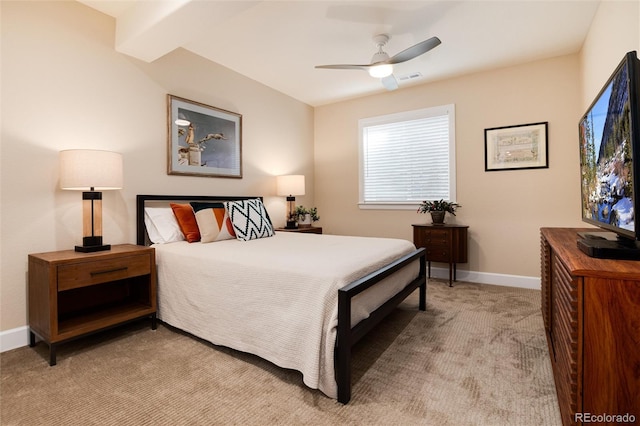 bedroom featuring ceiling fan, beam ceiling, and light colored carpet