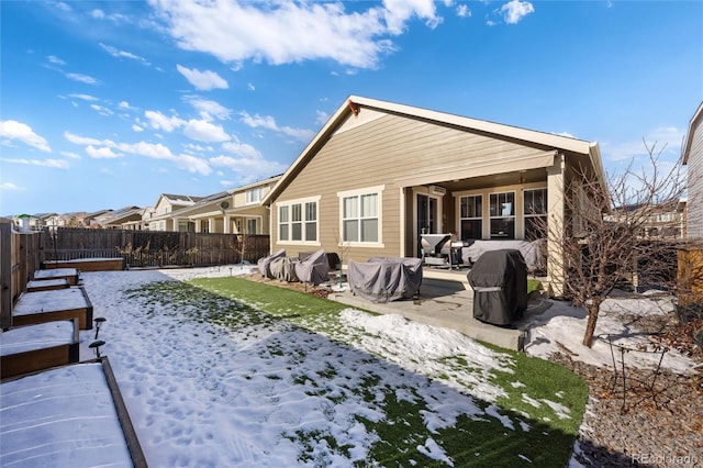 snow covered house with a patio area