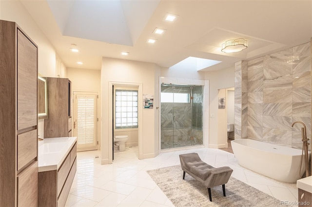 full bathroom with toilet, recessed lighting, vanity, a freestanding bath, and a stall shower