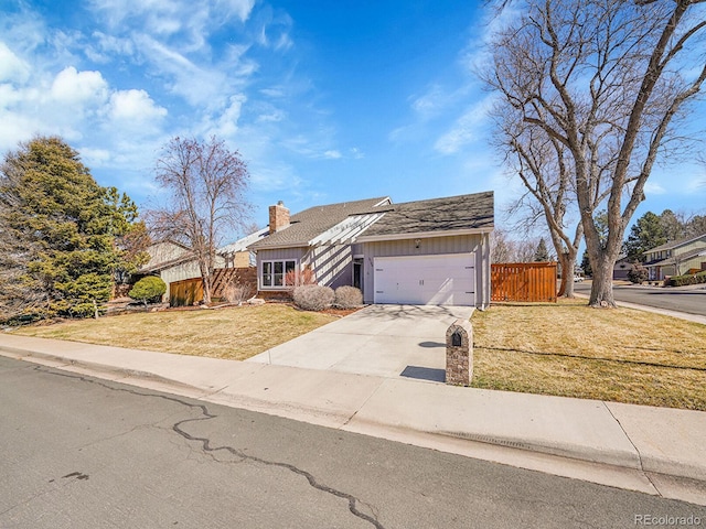 view of front of home featuring concrete driveway, a chimney, an attached garage, board and batten siding, and a front yard