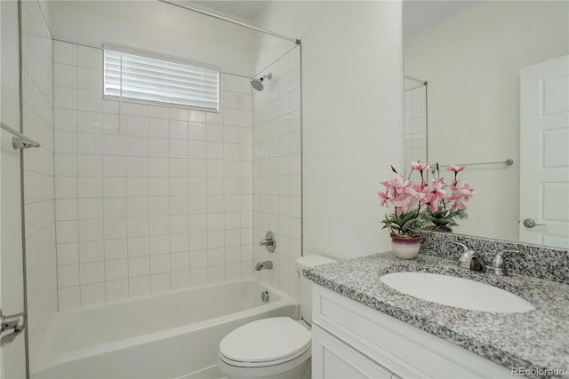 full bathroom featuring vanity, tiled shower / bath combo, and toilet