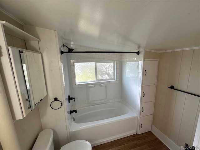 full bathroom featuring toilet, wood finished floors, and tub / shower combination