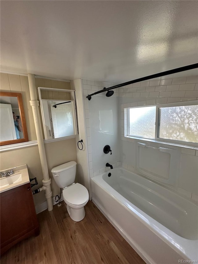 bathroom featuring shower / bath combination, vanity, toilet, and wood finished floors