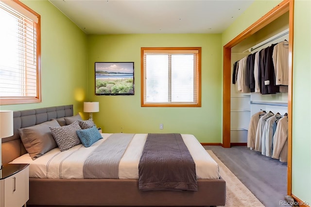 carpeted bedroom with baseboards and a closet