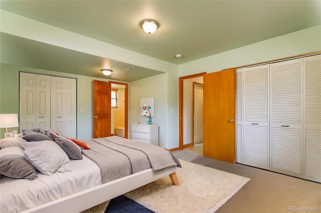 bedroom with a closet and light colored carpet