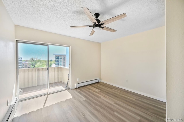 unfurnished room with baseboard heating, wood finished floors, a baseboard radiator, a textured ceiling, and a ceiling fan