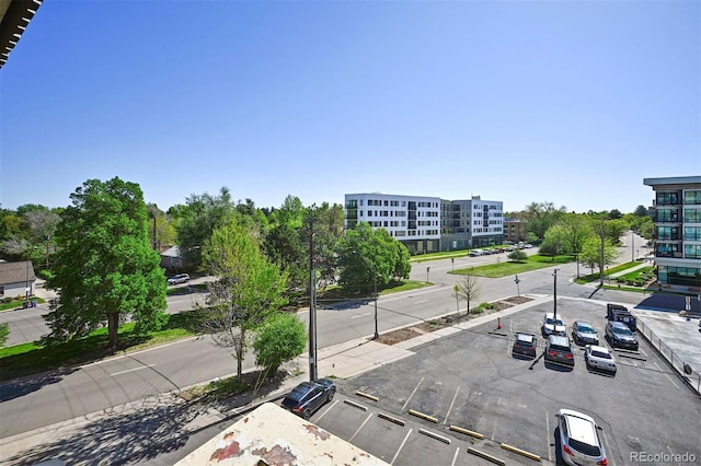 view of asphalt road featuring sidewalks and curbs