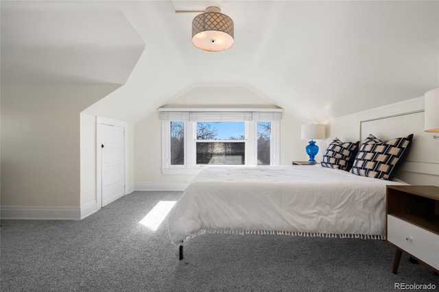 unfurnished bedroom with lofted ceiling and carpet