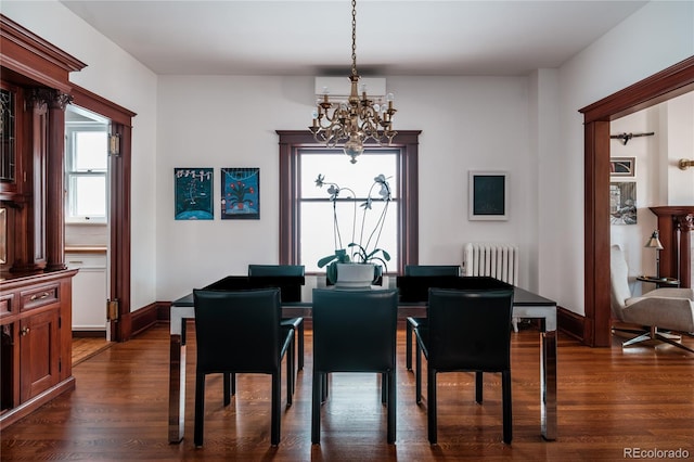 dining room featuring radiator heating unit, dark hardwood / wood-style flooring, and an inviting chandelier